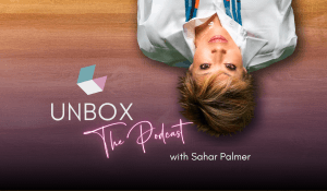 Sahar lying upside down announcing Unbox The Podcast