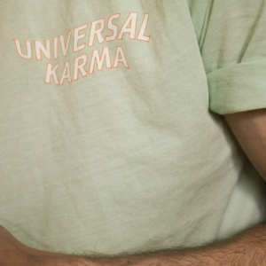 masculine arm of a man wearing green t-shirt