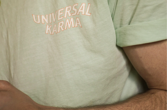masculine arm of a man wearing green t-shirt